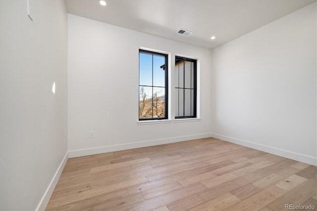 unfurnished room featuring light hardwood / wood-style floors