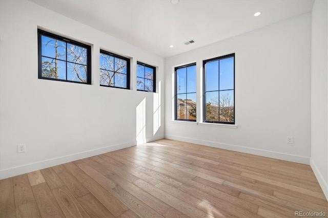 empty room with light hardwood / wood-style flooring