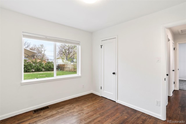 unfurnished bedroom featuring baseboards, visible vents, wood finished floors, and a closet