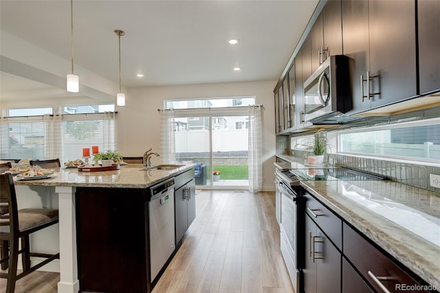 4444 N Picadilly Ct, Aurora, CO 80019 - kitchen with appliances with stainless steel finishes, recessed lighting, a sink, light wood-type flooring, and backsplash