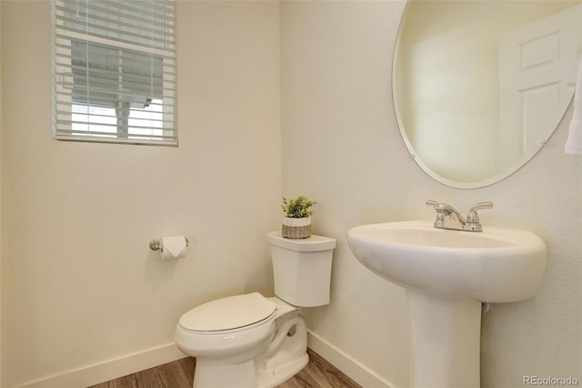4444 N Picadilly Ct, Aurora, CO 80019 - bathroom featuring toilet, wood finished floors, and baseboards