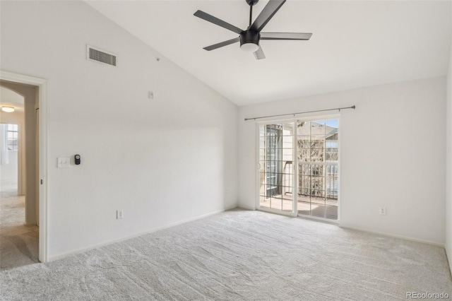 carpeted empty room with a ceiling fan, visible vents, and high vaulted ceiling