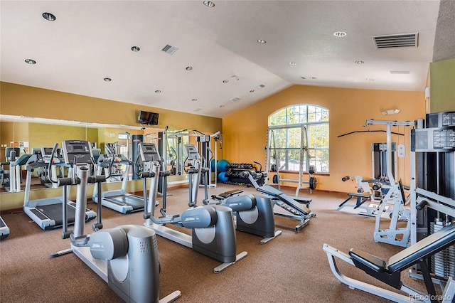 exercise room with visible vents, baseboards, and lofted ceiling