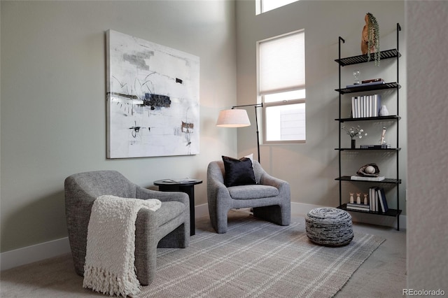 sitting room featuring carpet and baseboards