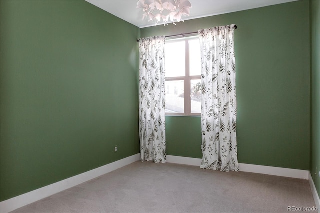 spare room with carpet floors and baseboards