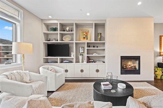 2826 Broadway St Unit 106, Boulder, CO 80304 - living area featuring wood finished floors, a tiled fireplace, built in features, and recessed lighting