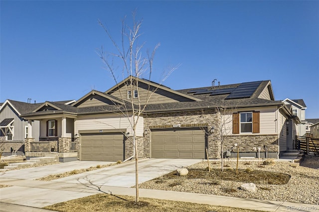 view of front of home featuring a garage and solar panels