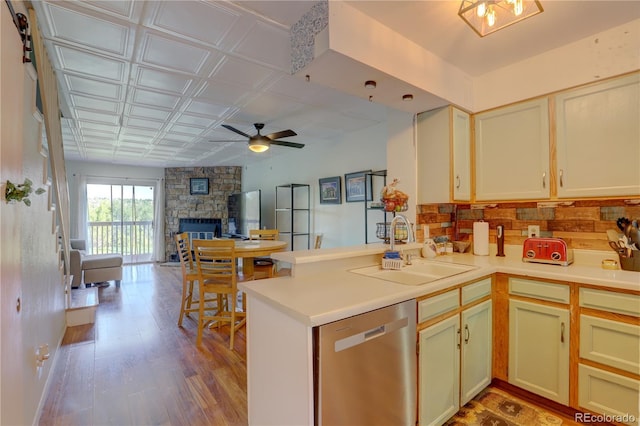 9771 W Cornell Pl, Lakewood, CO 80227 - kitchen featuring dishwasher, a sink, open floor plan, ceiling fan, and light countertops
