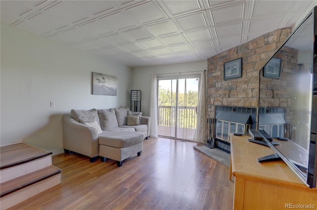 9771 W Cornell Pl, Lakewood, CO 80227 - living room featuring wood finished floors, a fireplace, and an ornate ceiling