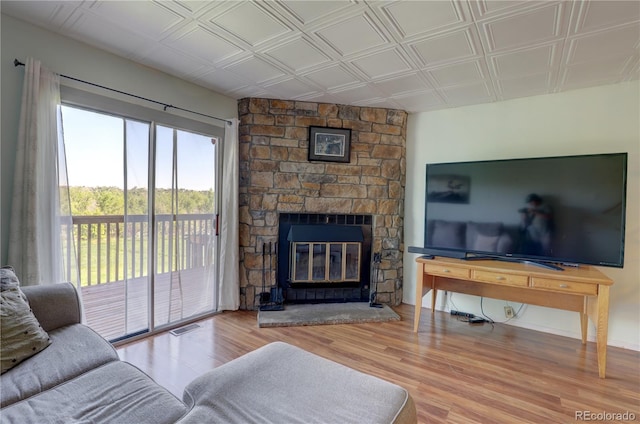 9771 W Cornell Pl, Lakewood, CO 80227 - living area with wood finished floors, a fireplace, and an ornate ceiling