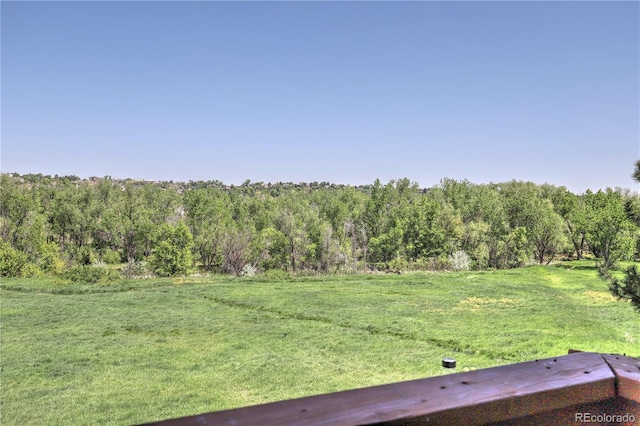 9771 W Cornell Pl, Lakewood, CO 80227 - view of grassy yard with a wooded view