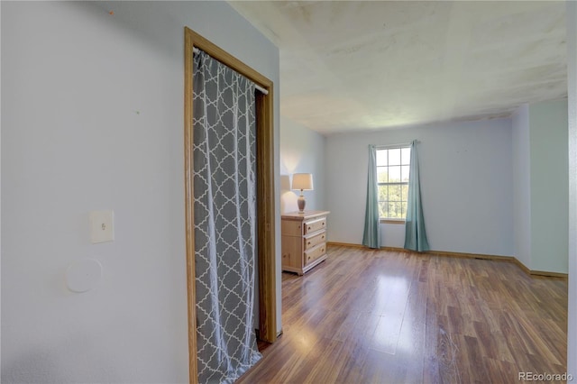 9771 W Cornell Pl, Lakewood, CO 80227 - unfurnished bedroom featuring wood finished floors and baseboards