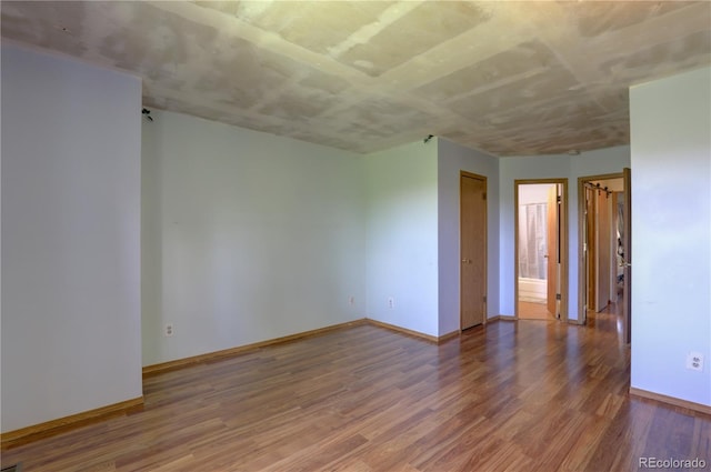 9771 W Cornell Pl, Lakewood, CO 80227 - spare room featuring wood finished floors and baseboards