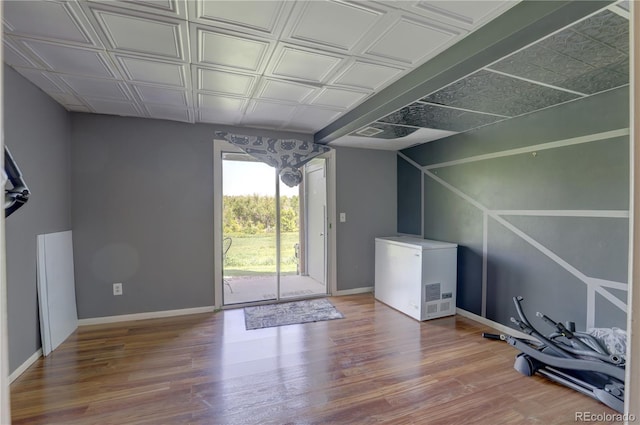 9771 W Cornell Pl, Lakewood, CO 80227 - garage with fridge, an ornate ceiling, and baseboards