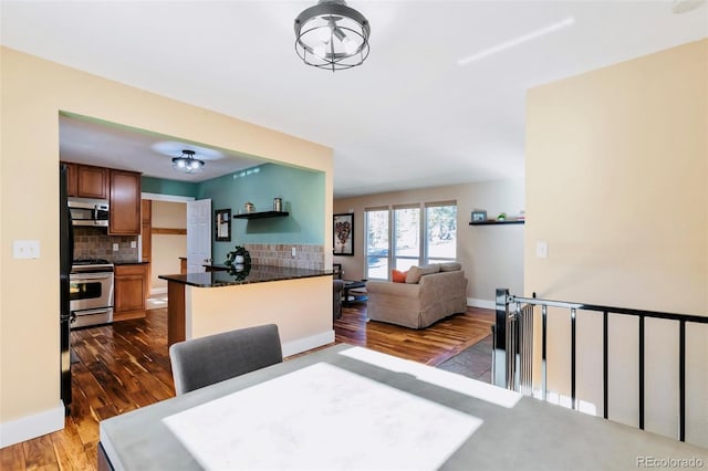 dining room with dark wood-type flooring and baseboards