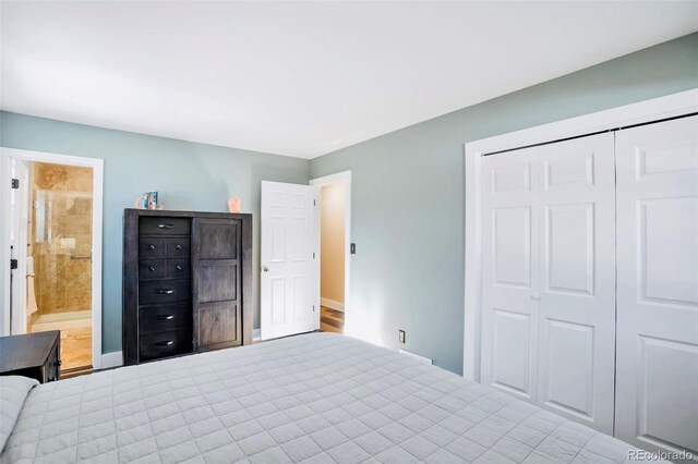 unfurnished bedroom with a closet, baseboards, and ensuite bath