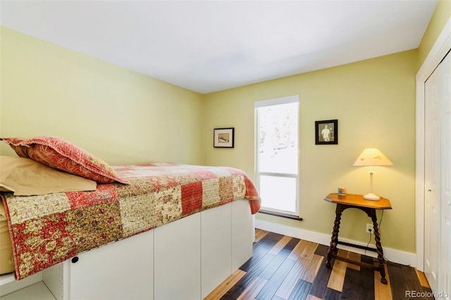 bedroom with baseboards and dark wood finished floors