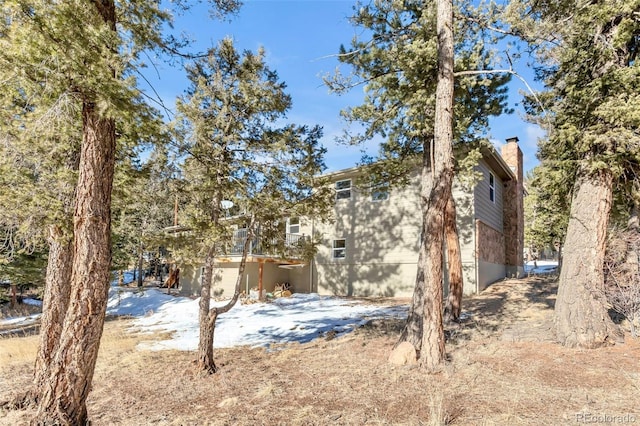view of side of home with a chimney