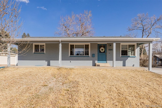 single story home featuring covered porch and brick siding