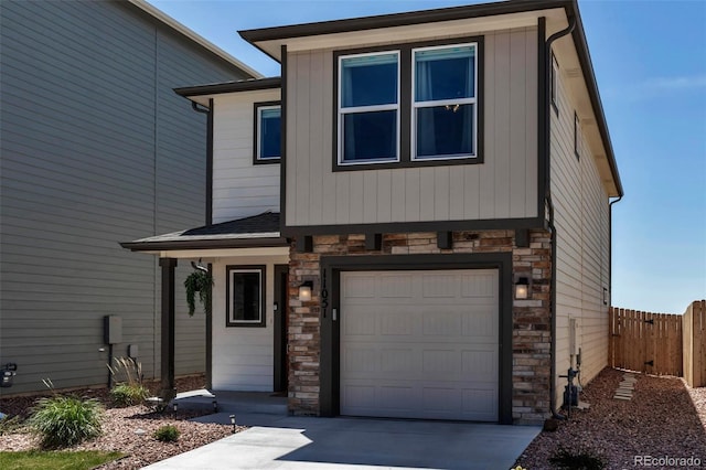 11051 Linley Way, Colorado Springs, CO 80908 - view of front facade featuring stone siding, an attached garage, and driveway