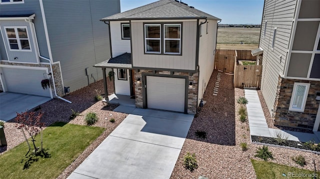 11051 Linley Way, Colorado Springs, CO 80908 - view of front facade featuring a shingled roof, a garage, stone siding, and driveway