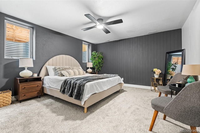 carpeted bedroom with ceiling fan, baseboards, and visible vents