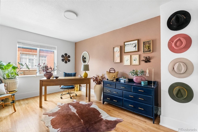 office space featuring light wood-style flooring and baseboards