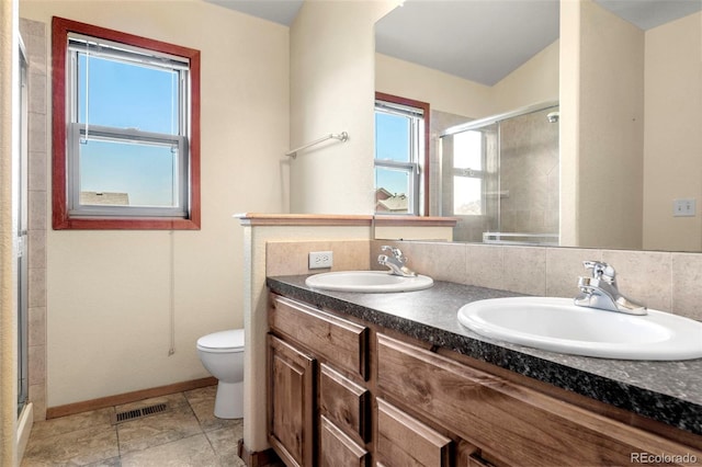 bathroom featuring double vanity, a sink, visible vents, and a shower stall