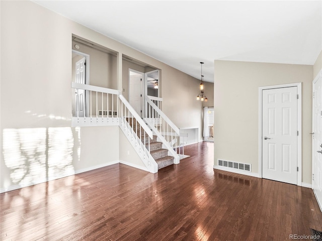 spare room featuring ceiling fan, dark hardwood / wood-style flooring, and lofted ceiling