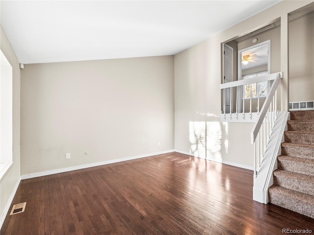 unfurnished living room with ceiling fan and dark hardwood / wood-style flooring