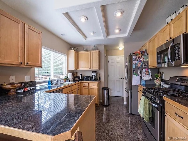 7053 Leopard Dr, Littleton, CO 80124 - kitchen with appliances with stainless steel finishes, light brown cabinetry, tile counters, a peninsula, and recessed lighting