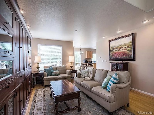 7053 Leopard Dr, Littleton, CO 80124 - living room featuring light wood-style flooring and a chandelier