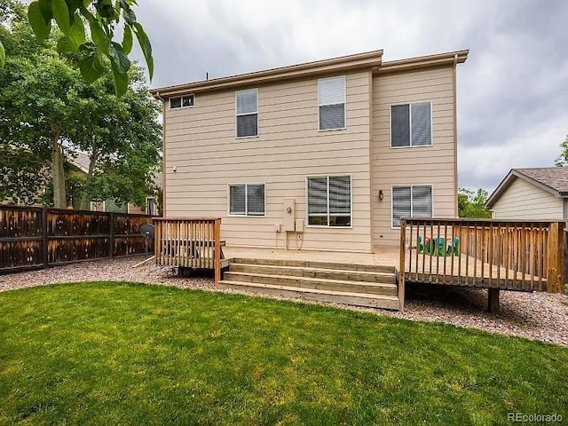 7053 Leopard Dr, Littleton, CO 80124 - back of property featuring a wooden deck and a fenced backyard