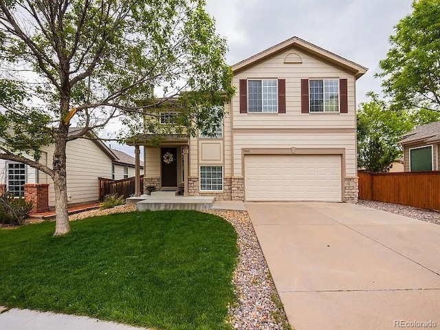 7053 Leopard Dr, Littleton, CO 80124 - view of front facade featuring a garage, stone siding, and concrete driveway