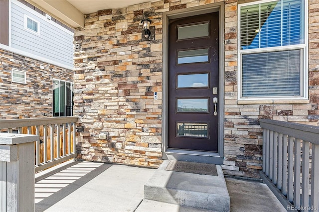 21761 E 7th Ave, Aurora, CO 80018 - property entrance featuring a porch and stone siding