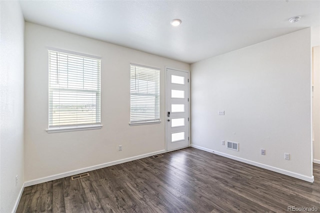 21761 E 7th Ave, Aurora, CO 80018 - empty room featuring dark wood finished floors, healthy amount of natural light, baseboards, and a smoke detector