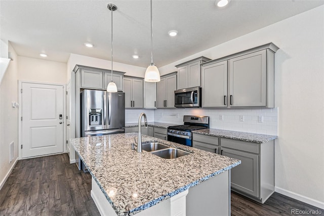 21761 E 7th Ave, Aurora, CO 80018 - kitchen with appliances with stainless steel finishes, gray cabinets, baseboards, a sink, and an island with sink