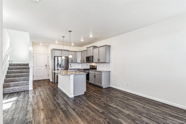 21761 E 7th Ave, Aurora, CO 80018 - kitchen with appliances with stainless steel finishes, gray cabinetry, dark wood-style floors, light stone counters, and recessed lighting