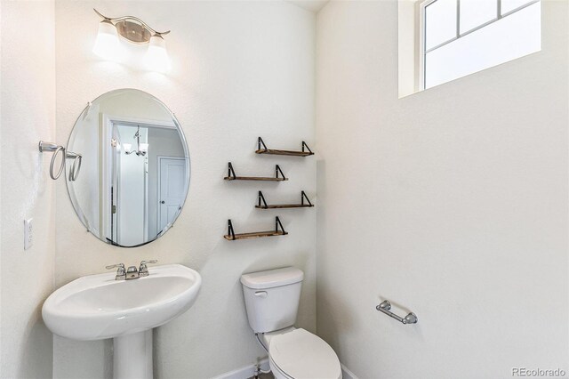 21761 E 7th Ave, Aurora, CO 80018 - half bathroom with toilet, a sink, and baseboards