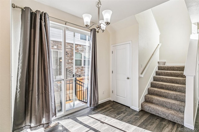 21761 E 7th Ave, Aurora, CO 80018 - foyer entrance with dark wood finished floors, a chandelier, baseboards, and stairway