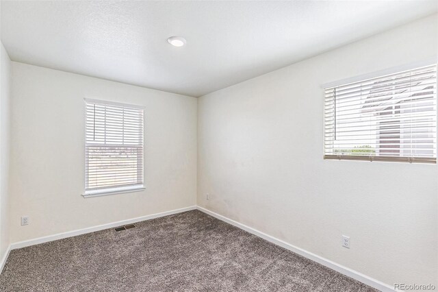 21761 E 7th Ave, Aurora, CO 80018 - carpeted spare room featuring baseboards
