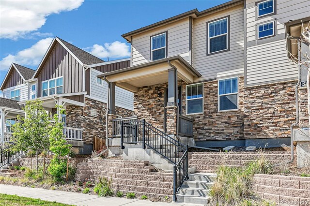 21761 E 7th Ave, Aurora, CO 80018 - multi unit property with covered porch, stone siding, and board and batten siding