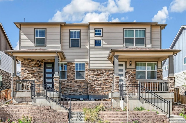 21761 E 7th Ave, Aurora, CO 80018 - view of front of house with covered porch, stone siding, stairway, and fence