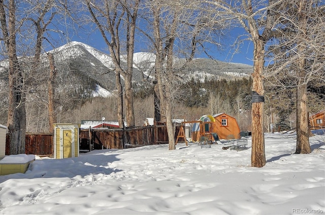 129 Lang St, Twin Lakes, CO 81251 - yard covered in snow with a playground, a mountain view, and a storage shed