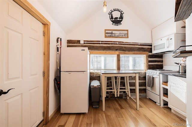 129 Lang St, Twin Lakes, CO 81251 - kitchen with white appliances, light wood-type flooring, lofted ceiling, and decorative backsplash