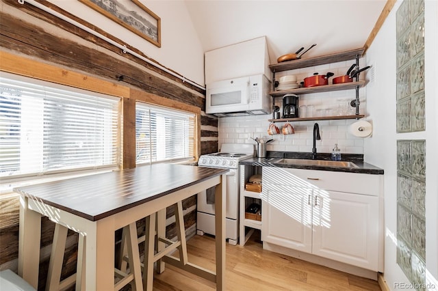 129 Lang St, Twin Lakes, CO 81251 - kitchen with white appliances, tasteful backsplash, light wood-type flooring, white cabinetry, and open shelves