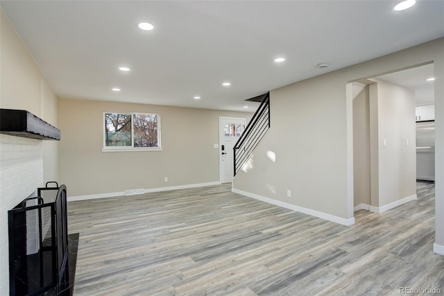 unfurnished living room featuring light hardwood / wood-style floors