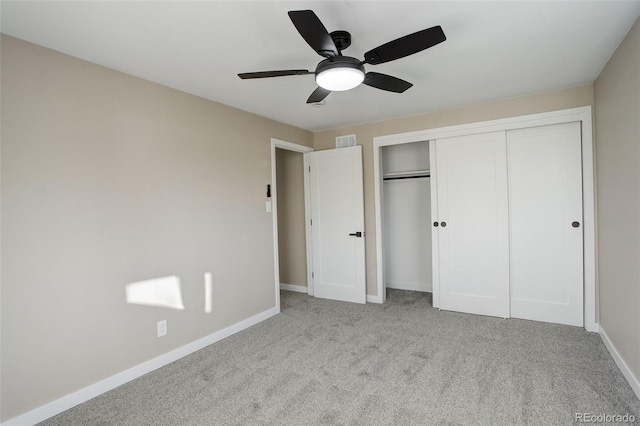 unfurnished bedroom with ceiling fan, a closet, and light colored carpet