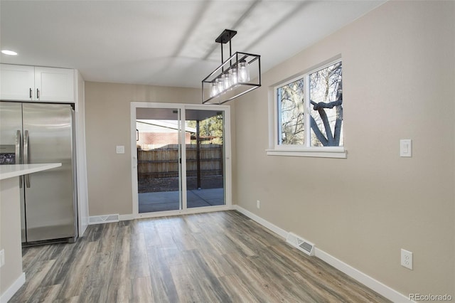 unfurnished dining area with hardwood / wood-style flooring