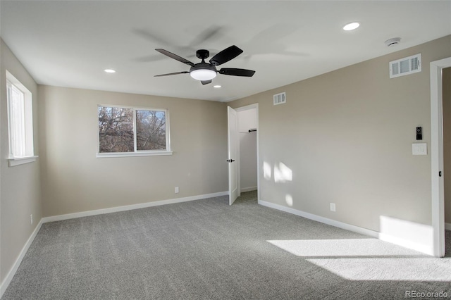 unfurnished room featuring ceiling fan, carpet, and plenty of natural light